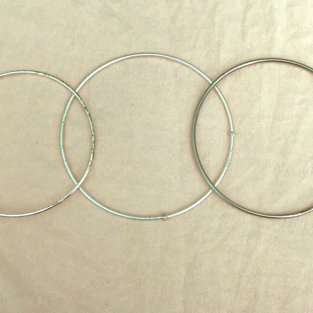 Three fake silver bracelets